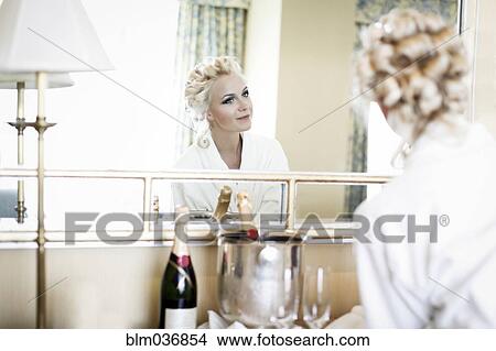 Caucasian woman admiring her hair in mirror View Large Photo Image Picture - Caucasian woman admiring her hair in mirror. Fotosearch