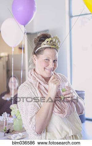 Caucasian woman drinking cocktail at party View Large Photo Image Stock Photograph - Caucasian woman drinking cocktail at party. Fotosearch