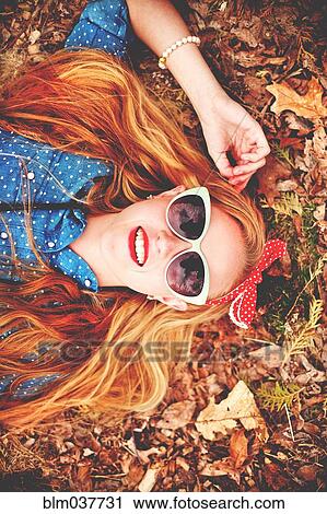Caucasian woman laying in autumn leaves View Large Photo Image Stock Image - Caucasian woman laying in autumn leaves. Fotosearch