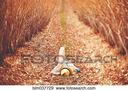 Caucasian woman laying on dirt path View Large Photo Image Stock Photo - Caucasian woman laying on dirt path. Fotosearch