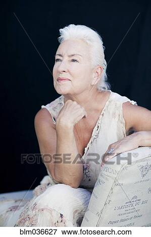 Stock Photo - Caucasian woman leaning on chair back. Fotosearch