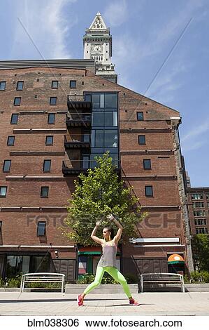 Stock Photograph - Caucasian woman posing on city sidewalk. Fotosearch