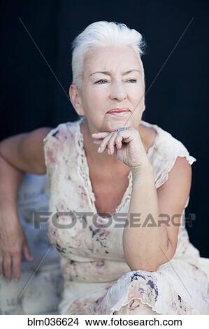 Picture - Caucasian woman resting chin in hand. Fotosearch