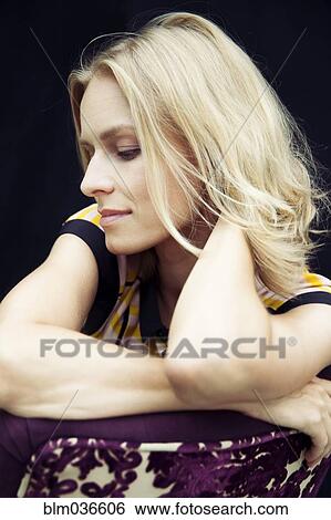 Caucasian woman sitting in chair View Large Photo Image Stock Photograph - Caucasian woman sitting in chair. Fotosearch