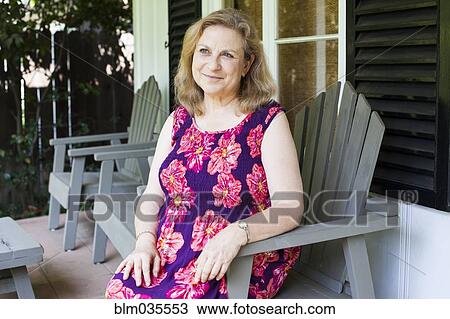 Caucasian woman sitting on porch View Large Photo Image Stock Image - Caucasian woman sitting on porch. Fotosearch
