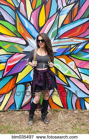 Caucasian woman smiling near multicolor mural View Large Photo Image Stock Photo - Caucasian woman smiling near multicolor mural. Fotosearch