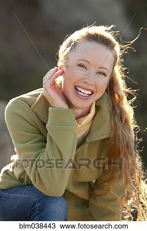 Stock Image - Caucasian woman smiling outdoors. Fotosearch