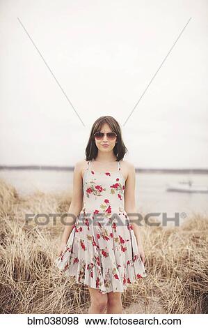 Caucasian woman standing in beach grass View Large Photo Image Stock Photo - Caucasian woman standing in beach grass. Fotosearch