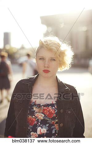 Stock Photo - Caucasian woman standing in city. Fotosearch