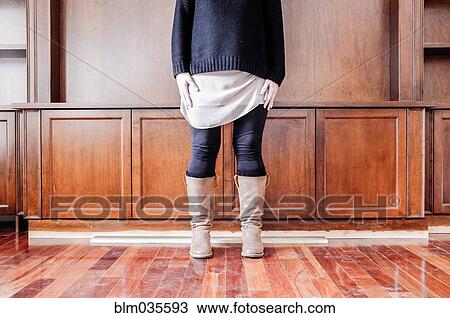 Caucasian woman standing in empty room View Large Photo Image Stock Image - Caucasian woman standing in empty room. Fotosearch