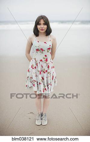 Caucasian woman standing on beach View Large Photo Image Stock Image - Caucasian woman standing on beach. Fotosearch