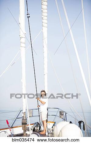 Caucasian woman standing on sailboat deck View Large Photo Image Picture - Caucasian woman standing on sailboat deck. Fotosearch