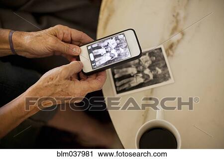 Caucasian woman taking cell phone picture of photograph View Large Photo Image Stock Image - Caucasian woman taking cell phone picture of photograph. Fotosearch