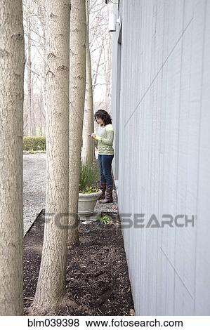 Caucasian woman using cell phone outdoors View Large Photo Image Stock Photo - Caucasian woman using cell phone outdoors. Fotosearch