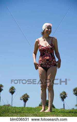 Caucasian woman wearing bathing suit in grass View Large Photo Image Stock Image - Caucasian woman wearing bathing suit in grass. Fotosearch