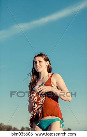 Caucasian woman wearing bikini under blue sky View Large Photo Image Stock Photography - Caucasian woman wearing bikini under blue sky. Fotosearch