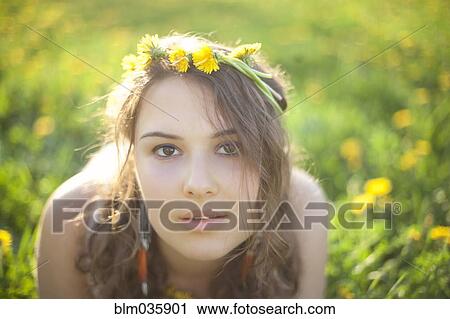Stock Image - Caucasian woman wearing flowers in her hair. Fotosearch