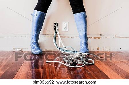 Caucasian woman wearing rain boots over electrical wiring View Large Photo Image Stock Image - Caucasian woman wearing rain boots over electrical wiring. Fotosearch