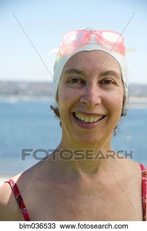 Caucasian woman wearing swim cap and goggles View Large Photo Image Stock Image - Caucasian woman wearing swim cap and goggles. Fotosearch
