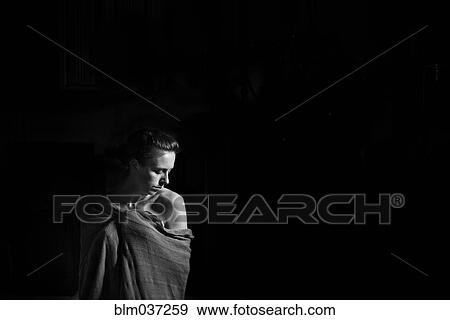 Stock Photo - Caucasian woman wrapped in blanket. Fotosearch