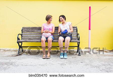 Caucasian women talking on bench View Large Photo Image Stock Image - Caucasian women talking on bench. Fotosearch