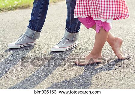 Children barefoot and with sneakers standing on concrete View Large Photo Image Stock Image - Children barefoot and with sneakers standing on concrete. Fotosearch