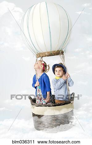 Stock Image - Children playing in pretend hot air balloon. Fotosearch