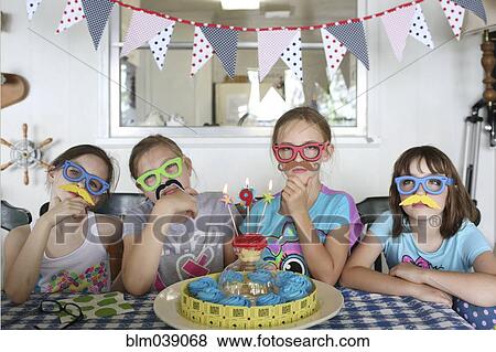 Stock Photo - Children wearing disguises at birthday party. Fotosearch