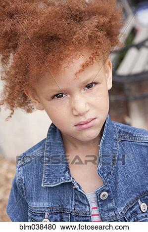 Stock Image - Close up of angry girl frowning. Fotosearch