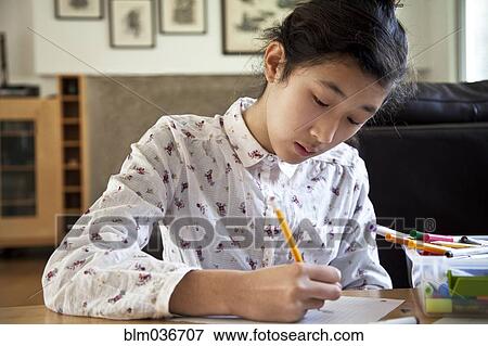 Close up of Asian teenage girl doing homework View Large Photo Image Stock Photo - Close up of Asian teenage girl doing homework. Fotosearch
