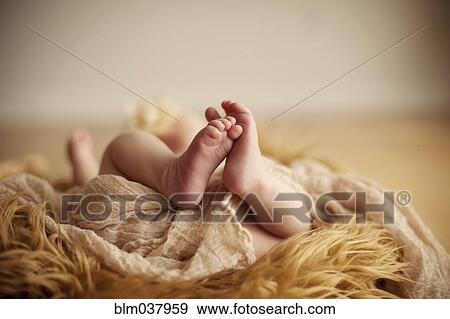 Stock Photo - Close up of baby girl on furry carpet. Fotosearch