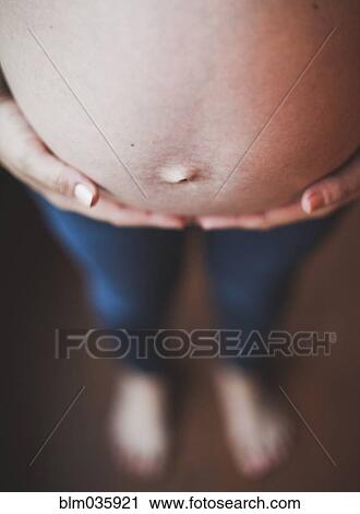 Close up of belly of pregnant Caucasian woman View Large Photo Image Stock Image - Close up of belly of pregnant Caucasian woman. Fotosearch