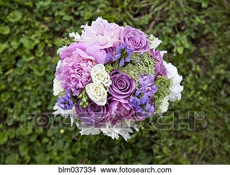 Close up of bouquet of flowers in grass View Large Photo Image Picture - Close up of bouquet of flowers in grass. Fotosearch