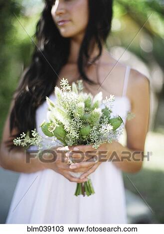 Close up of bride holding bouquet of flowers View Large Photo Image Stock Image - Close up of bride holding bouquet of flowers. Fotosearch