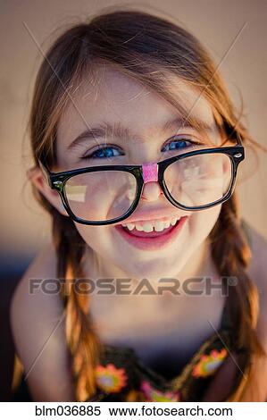 Close up of Caucasian girl wearing eyeglasses View Large Photo Image Stock Photography - Close up of Caucasian girl wearing eyeglasses. Fotosearch