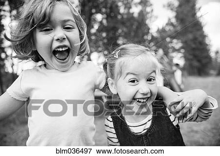 Close up of Caucasian sisters hugging outdoors View Large Photo Image Stock Photo - Close up of Caucasian sisters hugging outdoors. Fotosearch