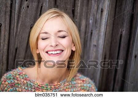 Close up of Caucasian woman laughing with eyes closed View Large Photo Image Stock Image - Close up of Caucasian woman laughing with eyes closed. Fotosearch