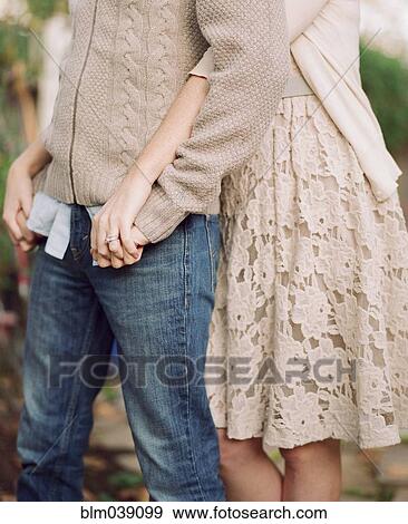 Close up of couple hugging in backyard View Large Photo Image Stock Photo - Close up of couple hugging in backyard. Fotosearch