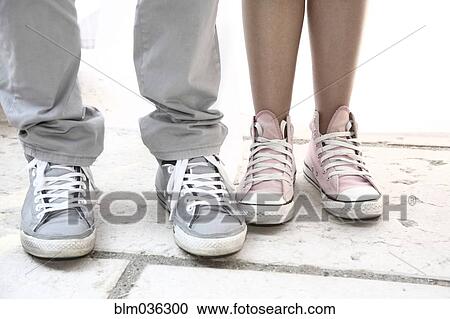 Close up of couple wearing sneakers View Large Photo Image Stock Image - Close up of couple wearing sneakers. Fotosearch
