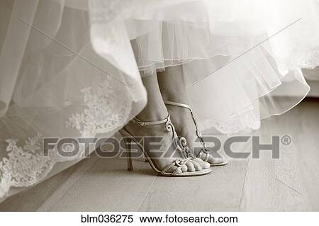 Stock Photography - Close up of feet of bride in wedding shoes. Fotosearch