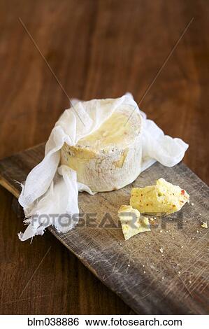 Stock Photograph - Close up of fresh cheese on cutting board. Fotosearch