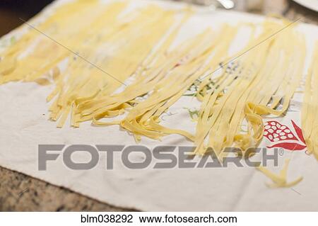 Stock Image - Close up of fresh pasta on cloth. Fotosearch
