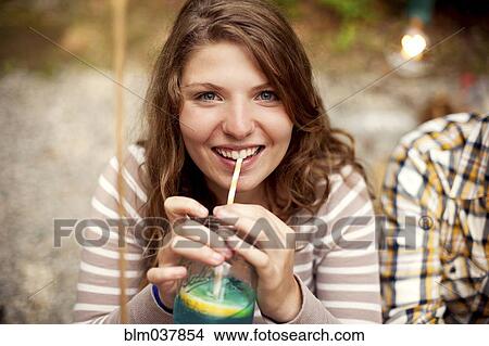 Close up of girl drinking beverage with straw View Large Photo Image Picture - Close up of girl drinking beverage with straw. Fotosearch