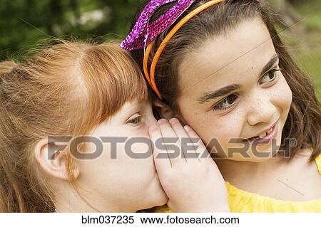 Close up of girls whispering outdoors View Large Photo Image Stock Photography - Close up of girls whispering outdoors. Fotosearch