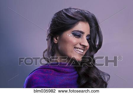 Stock Image - Close up of glamorous smiling Pakistani woman. Fotosearch