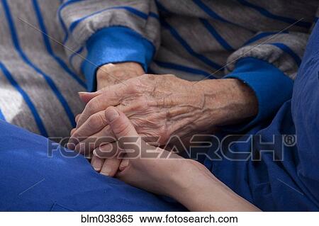 Close up of granddaughter holding hands of grandmother View Large Photo Image Stock Photography - Close up of granddaughter holding hands of grandmother. Fotosearch
