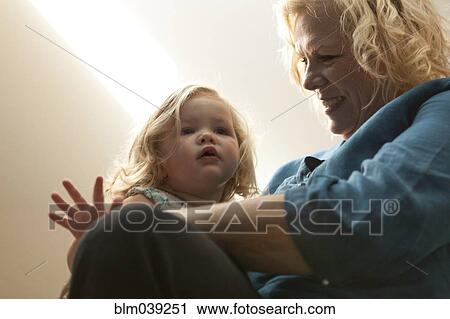 Close up of grandmother holding granddaughter View Large Photo Image Stock Image - Close up of grandmother holding granddaughter. Fotosearch