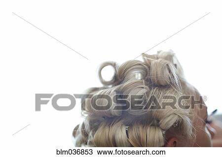 Stock Image - Close up of hair of Caucasian woman in rollers. Fotosearch