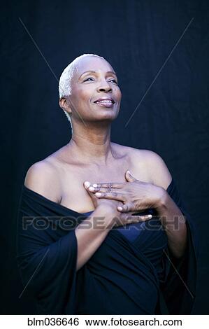 Stock Photograph - Close up of hopeful woman looking up. Fotosearch