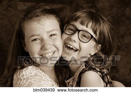 Stock Photo - Close up of laughing Caucasian girls. Fotosearch